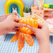 Tangerine Cutie Peeling Fidget - hands peeling the tangerine toy showing stretchy texture